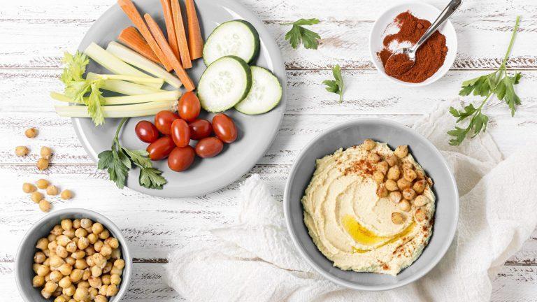 מגש חומוס עם ירקות טריים וטחינה בסגנון ים תיכוני טבעוני